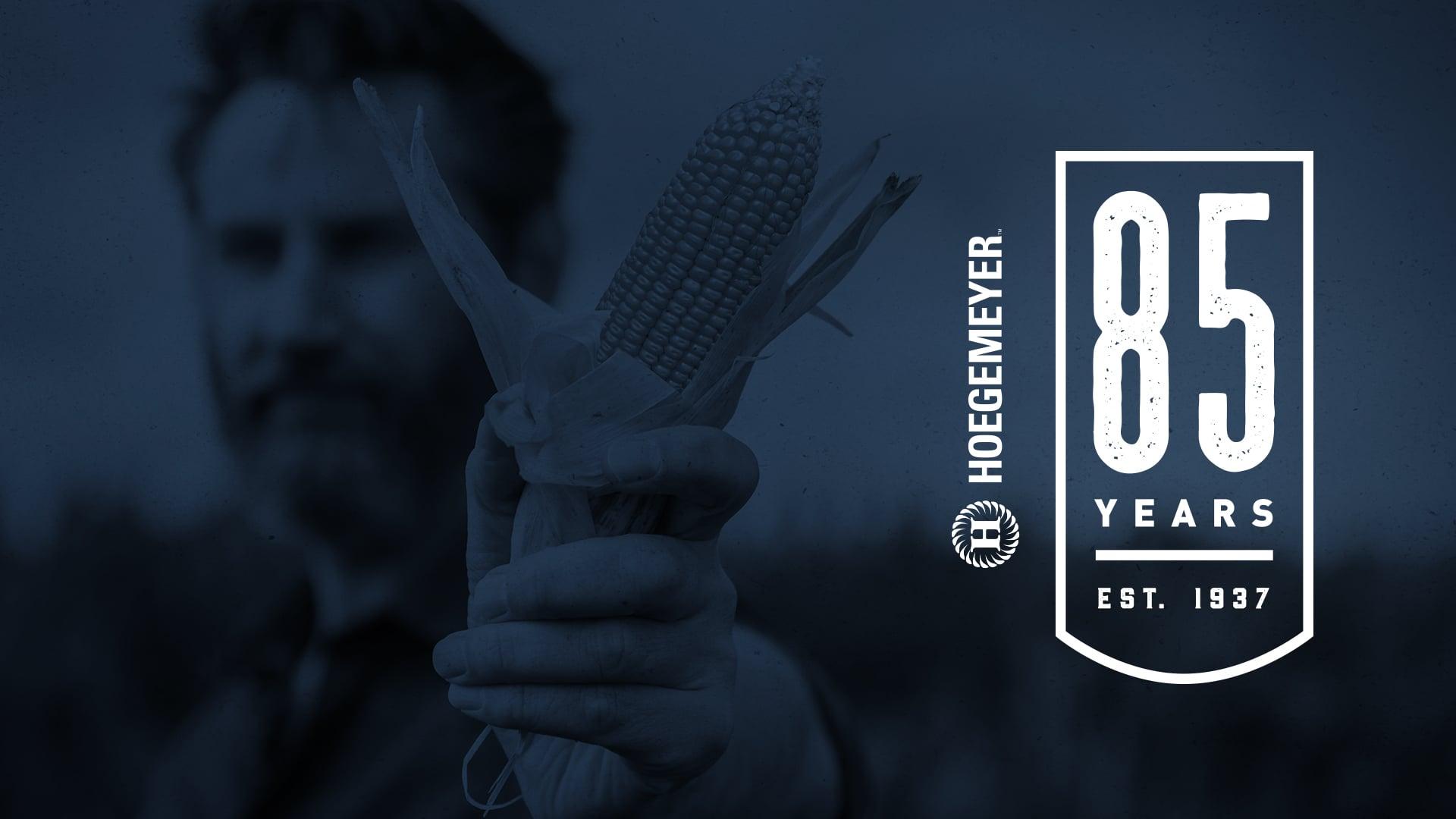 Hoegemeyer 85 years poster with man holding corn