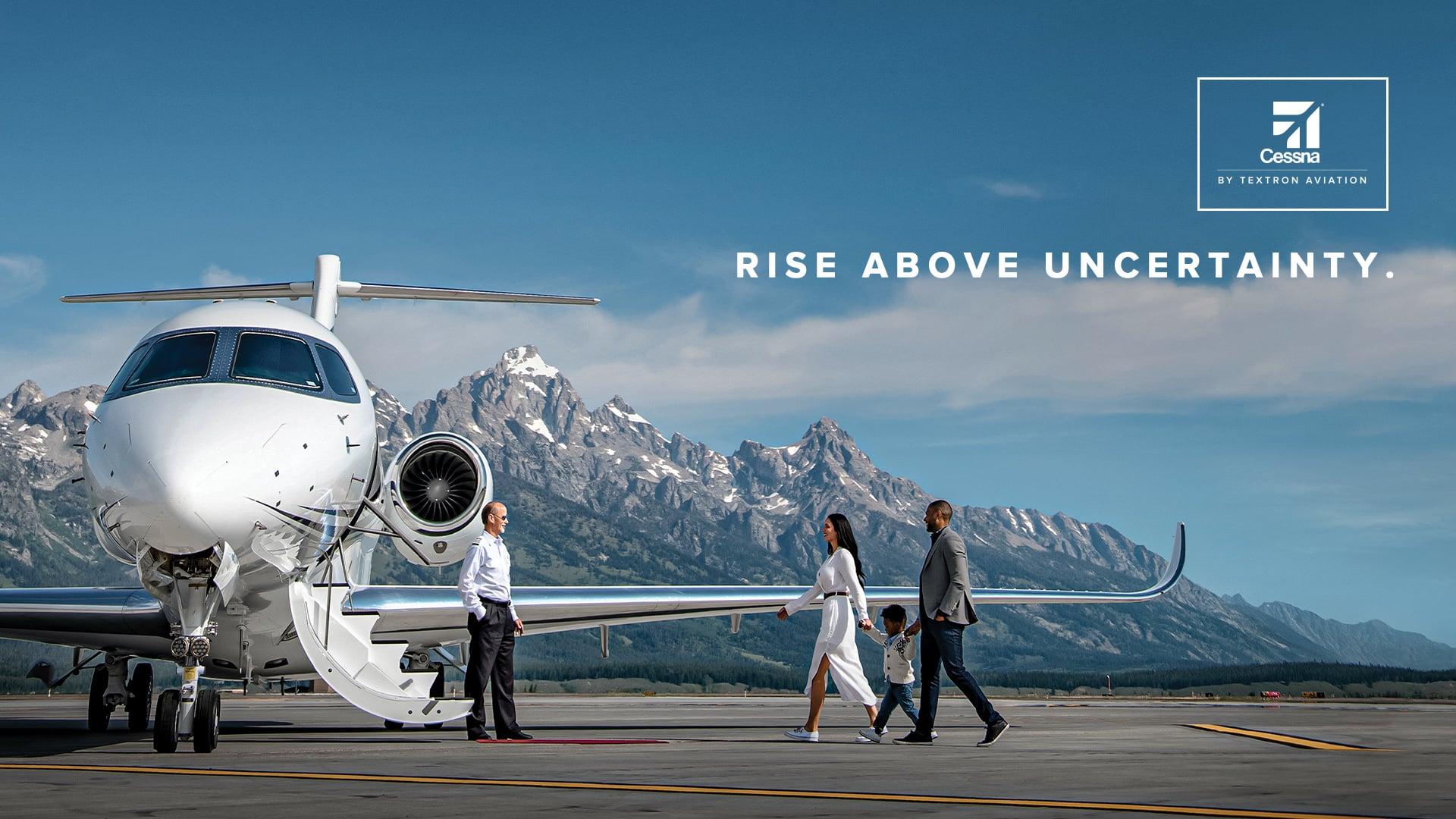 Couple walking up to airplane in front of mountain